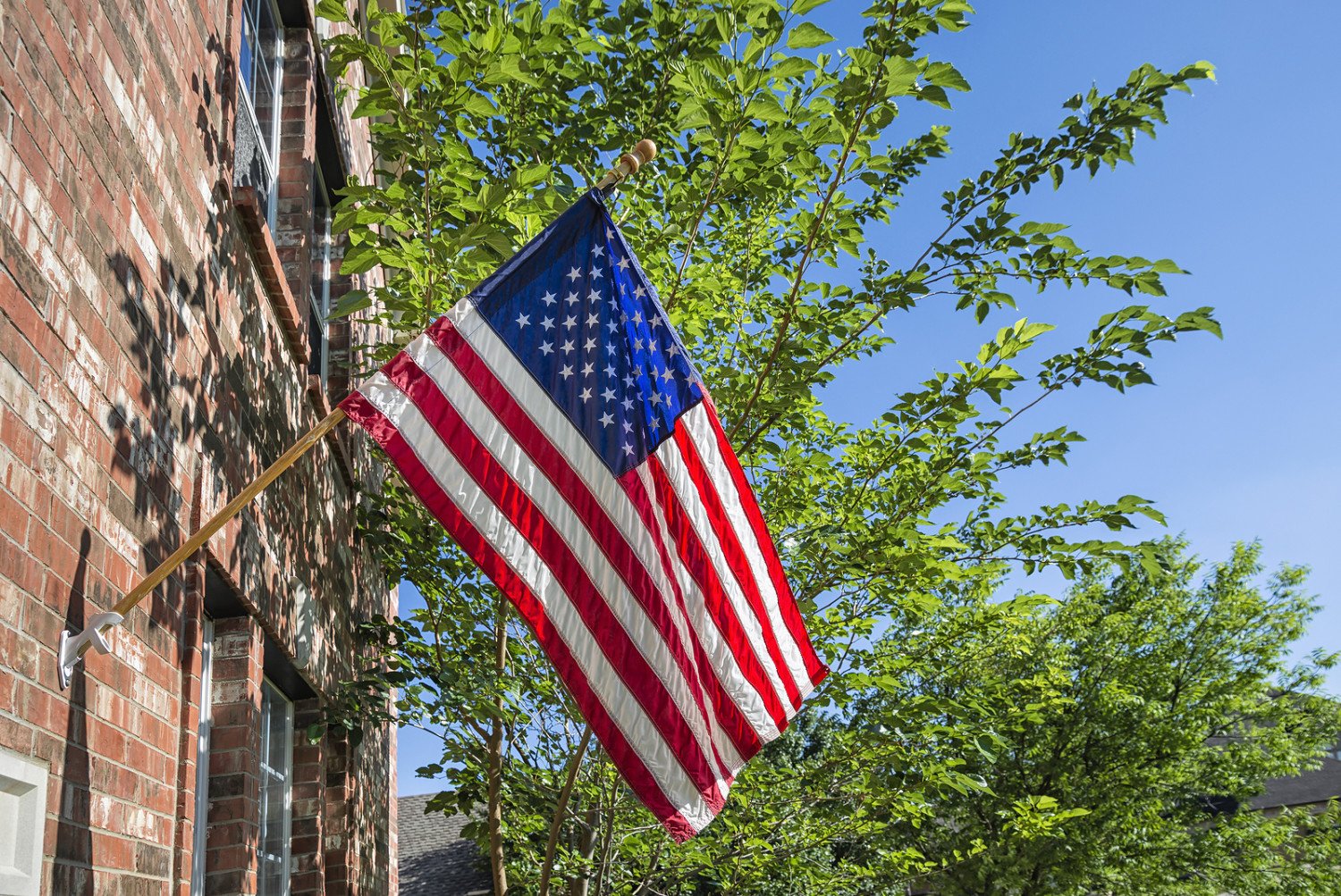 Preparing Your Historic Home for Memorial Day Hanging a Flag on Brick