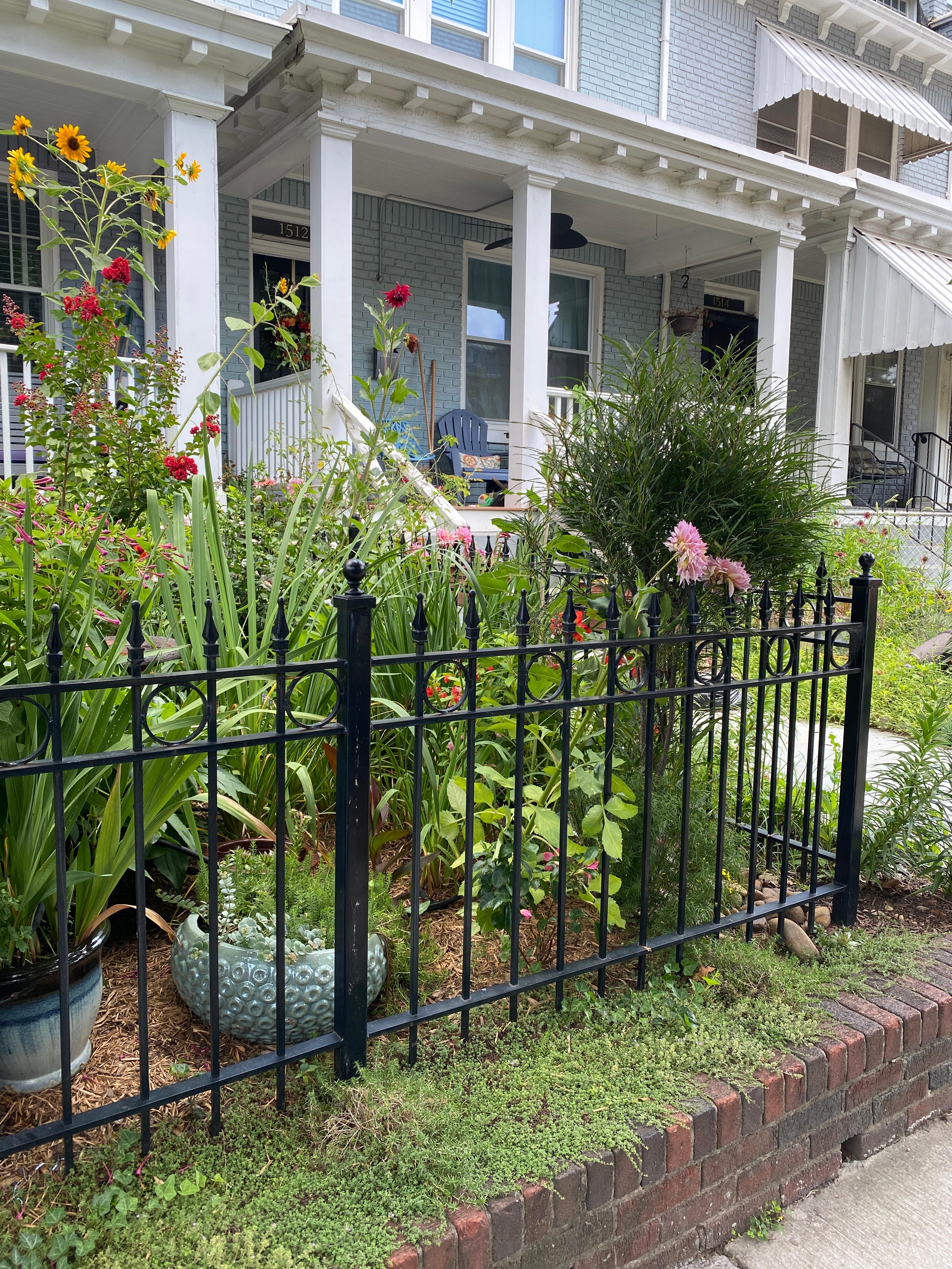 A flower garden held up by a brick retaining wall. Renaissance Develpment DC