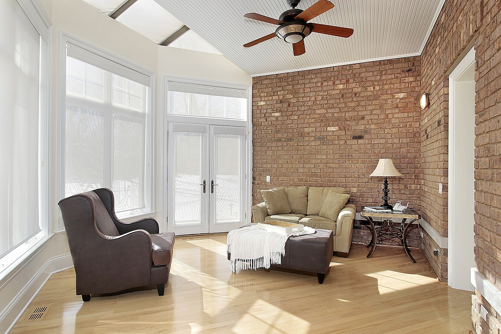Family room with an exposed interior brick wall Renaissance Development DC