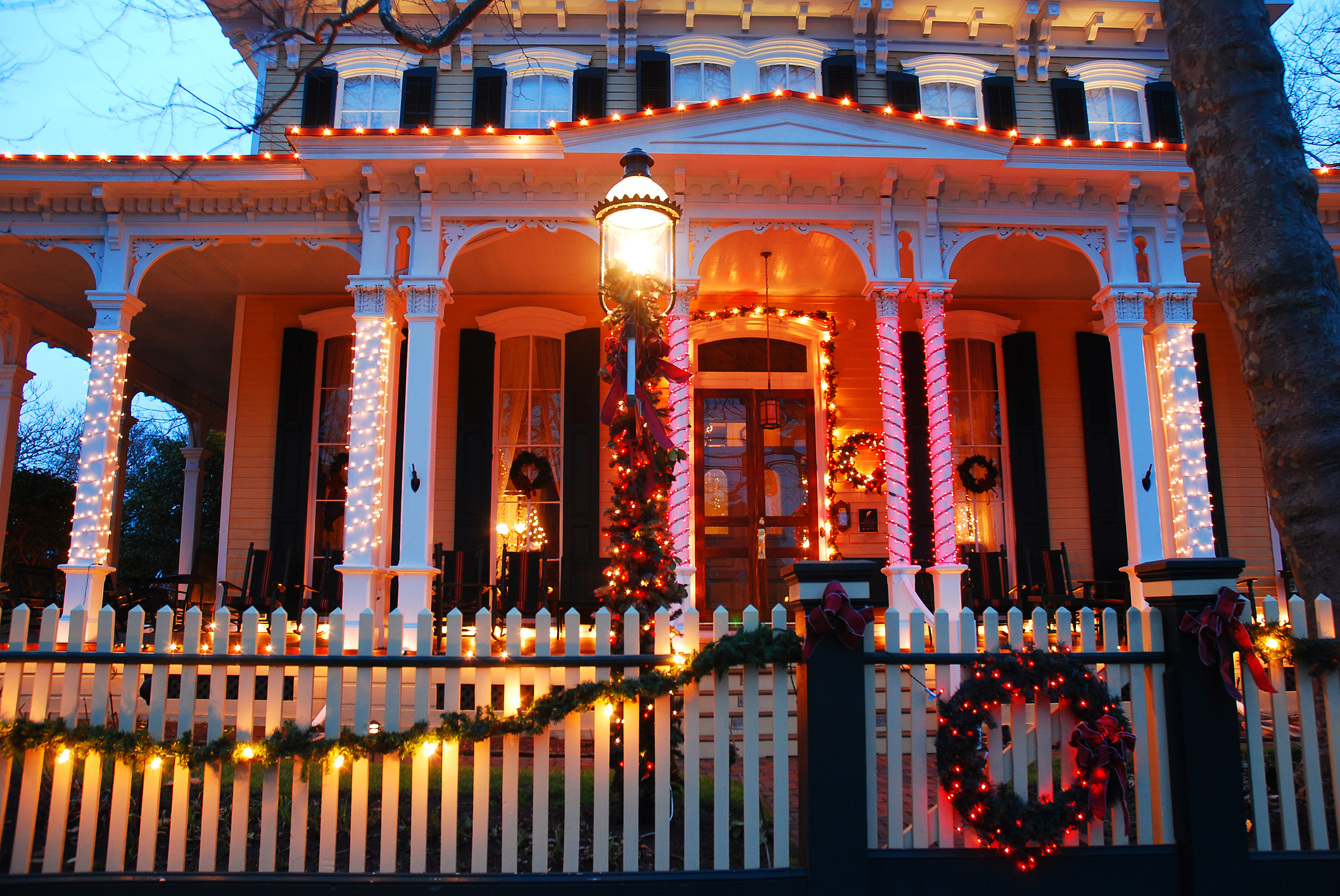 The exterior of an elegant Victorian era home beautifully decorated for the Christmas holidays